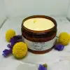 After Sun Body Cream texture surrounded by daisy pom poms, natural skin relief