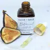 Botanical AHA Face Oil with dropper out and cut fig, enhancing exfoliation and skin radiance.