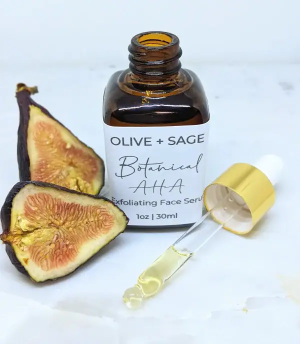 Botanical AHA Face Oil with dropper out and cut fig, enhancing exfoliation and skin radiance.