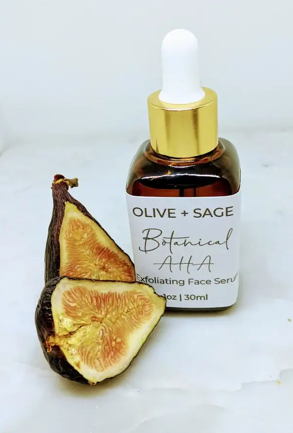 Botanical AHA Face Oil in a glass dropper bottle with a cut fig, promoting exfoliation and skin rejuvenation.