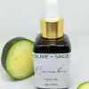 Closed glass dropper bottle of Organic Cucumber Face Oil with sliced cucumbers around it.