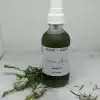 Pump bottle of Enhanced Vein Oil with pine decorations, designed to support circulation and improve skin tone.
