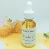 Close-up of Manuka Flower Skin Serum dropper bottle with honey