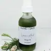 Natural Vein Oil in a pump bottle, labeled, with pine decorations for enhanced circulation and smoother skin.