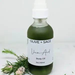 Natural Vein Oil in a pump bottle, labeled, with pine decorations for enhanced circulation and smoother skin.