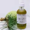 Close-up of Organic After Shave Oil in glass spray bottle with pine cone and natural elements.