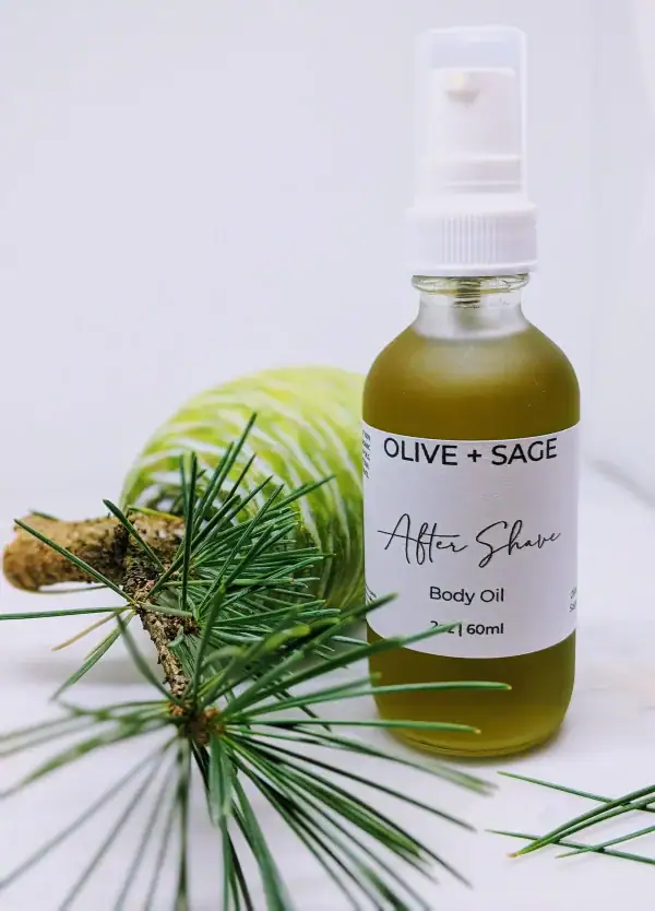 Close-up of Organic After Shave Oil in glass spray bottle with pine cone and natural elements.