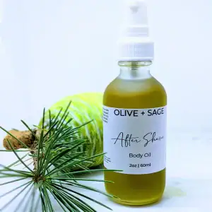Organic After Shave Oil in a glass spray bottle with pine cone next to it.