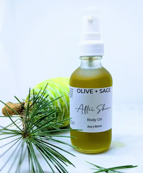 Organic After Shave Oil in a glass spray bottle with pine cone next to it.