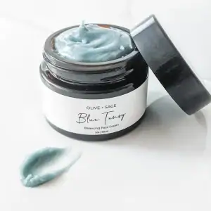 Organic Blue Tansy Moisturizer smear showing smooth texture and botanical-rich consistency.