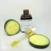 Organic Cucumber Face Oil in glass dropper bottle with dropper out and fresh sliced cucumbers.