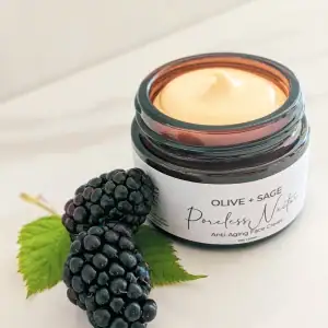 Organic Poreless Nectar Face Cream texture with blackberries next to jar