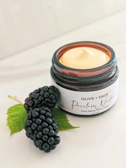 Organic Poreless Nectar Face Cream texture with blackberries next to jar