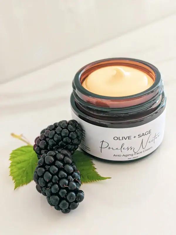 Organic Poreless Nectar Face Cream texture with blackberries next to jar