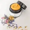 Organic rosacea face cream in open glass jar, showcasing smooth, rich texture for calming red, sensitive skin.