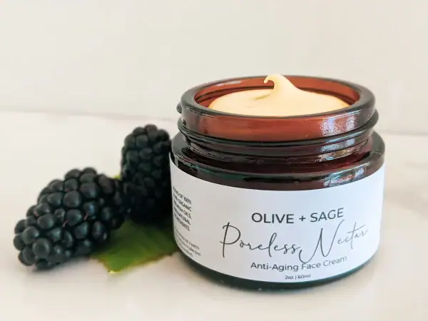 glass jar of pore minimizing face cream showing smooth, whipped texture