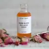 Rose Glow Anti-Aging Serum dropper bottle with the dropper out and dried mini roses