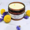 After Sun Body Cream texture with daisy pom poms, natural soothing cream