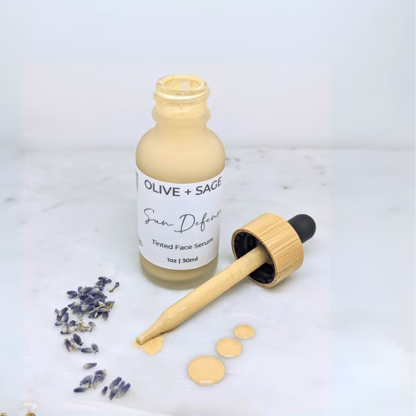 Sun Defense Face Oil with dropper showing the oil's texture and color