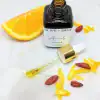 Close-up of Vitamin C Face Oil dropper with oranges – glowing skin serum with THD Ascorbate
