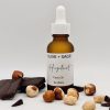 Angled studio view of Olive + Sage’s organic face oil with hazelnuts and chocolate