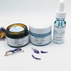 Blue Lotus Face Cream, Face Oil, and Face Scrub displayed together with blue lotus leaves. A complete skincare ritual for sensitive skin.