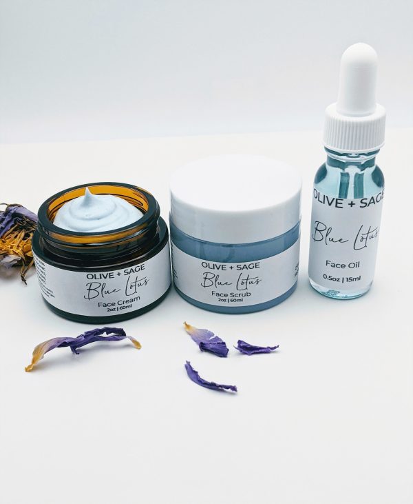 Blue Lotus Face Cream, Face Oil, and Face Scrub displayed together with blue lotus leaves. A complete skincare ritual for sensitive skin.