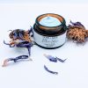 ngled view of Blue Lotus Face Cream jar with visible creamy texture and lotus leaves. Made with squalane, cupuaçu butter, and calming oils.