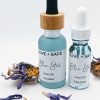 Blue Lotus Face Oil 1 oz and 0.5 oz glass bottles with blue lotus flowers, natural facial oils for hydration and skin calm