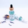 Blue Lotus Face Oil 1 oz and 0.5 oz glass bottles side by side with blue lotus flowers, calming facial oils for sensitive skin