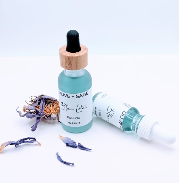 Blue Lotus Face Oil 1 oz and 0.5 oz glass bottles side by side with blue lotus flowers, calming facial oils for sensitive skin