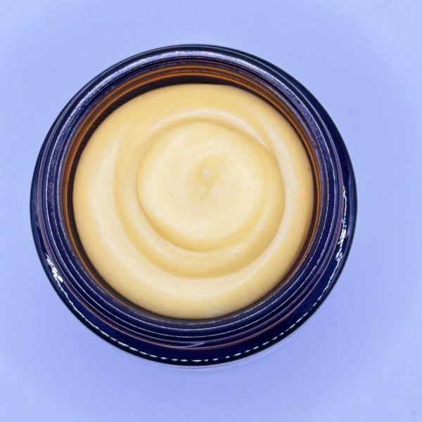 Top view of Recovery Face Cream with golden whipped texture