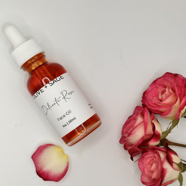 Delicate Rose Face Oil flatlay styled with pink roses